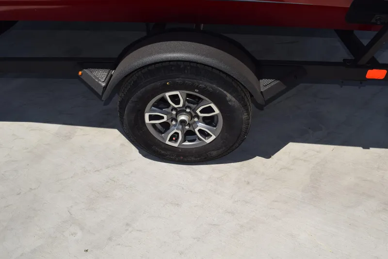 Slide: The Image of Trailer wheel of 2025 Tracker Pro Team 175 boat on concrete surface. - 8