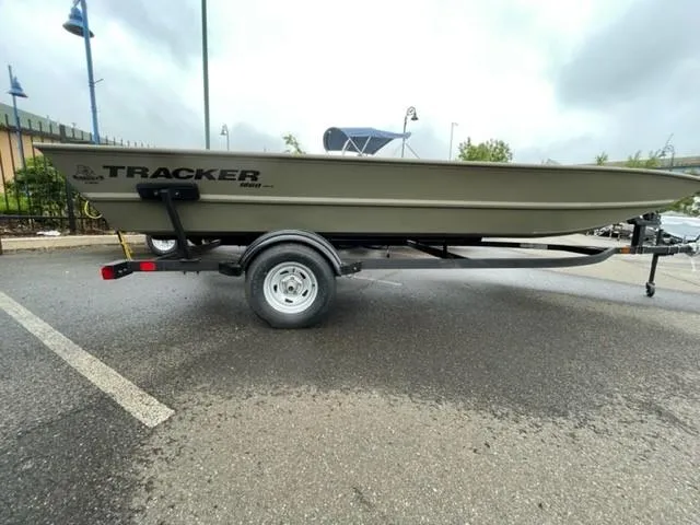 The Image of 2025 Tracker GRIZZLY 1860 Utility boat on trailer in parking lot. - 0