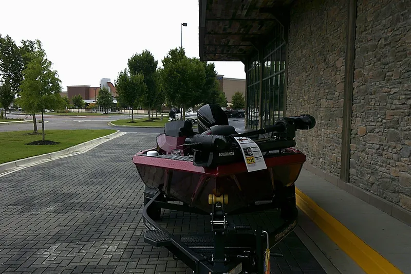 Slide: The Image of 2025 Ranger RT178 boat on trailer outside a stone building. - 2