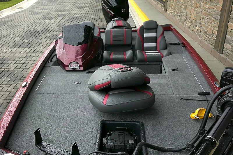 Slide: The Image of 2025 Ranger RT178 boat interior with gray and red seating, wet from rain. - 4
