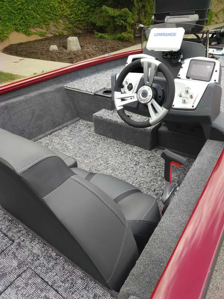 Slide: The Image of 2025 Tracker Pro Team 175 boat interior with steering wheel and navigation system. - 2