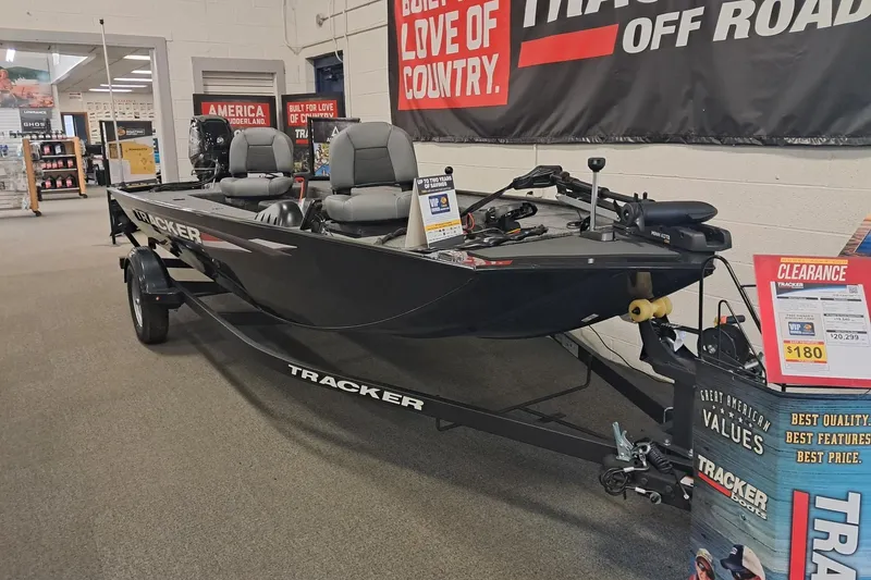 The Image of 2025 Tracker Panfish 17 boat on display in showroom with promotional banners. - 0