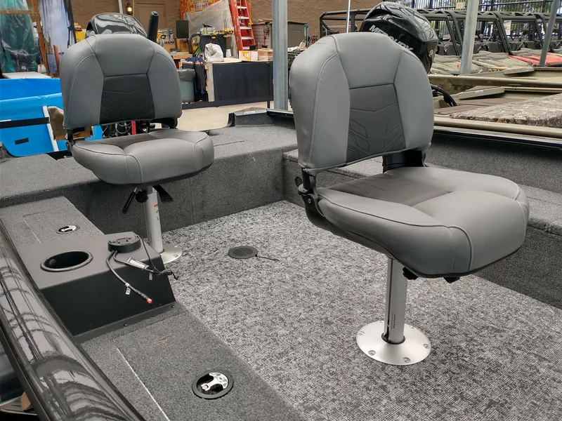 Slide: The Image of 2025 Tracker Super Guide V-16 T boat interior with two gray swivel seats. - 3