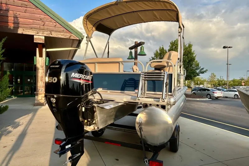 Slide: The Image of 2025 Sun Tracker Bass Buggy 16 XL Select pontoon boat with Mercury 150 engine. - 6