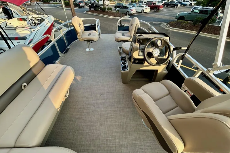 Slide: The Image of 2025 Sun Tracker Bass Buggy 16 XL Select pontoon boat interior with beige seating. - 8
