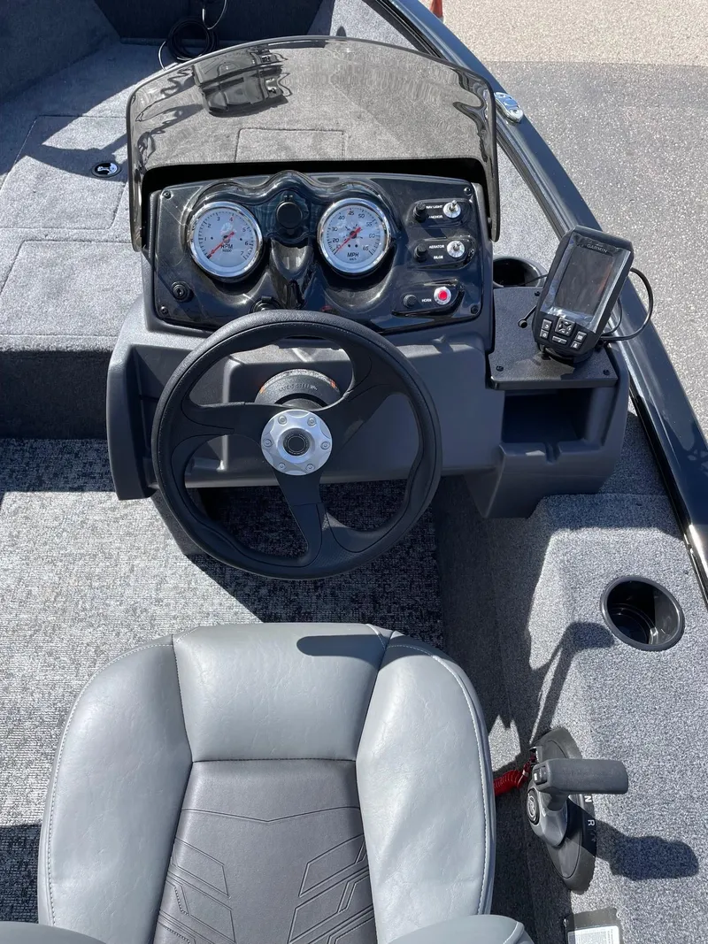 Slide: The Image of 2025 Tracker Super Guide V-16 SC boat dashboard with steering wheel and gauges. - 4