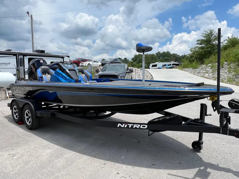 Slide: The Image of 2025 Nitro Z20 XL boat on trailer under cloudy sky. - 13