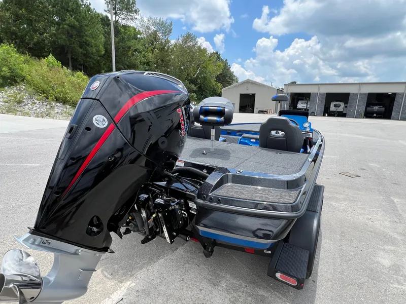 Slide: The Image of 2025 Nitro Z20 XL boat with powerful outboard motor in a parking area. - 3