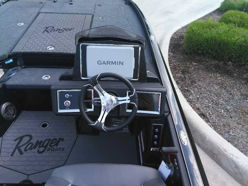 Slide: The Image of 2025 Ranger Z521R Cup-Equipped boat dashboard with Garmin display and steering wheel. - 6