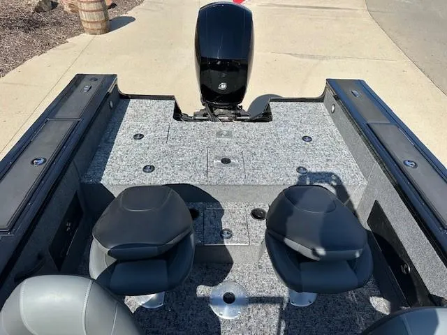 Slide: The Image of 2025 Tracker Targa V-18 WT boat interior with seating and motor, viewed from above. - 10