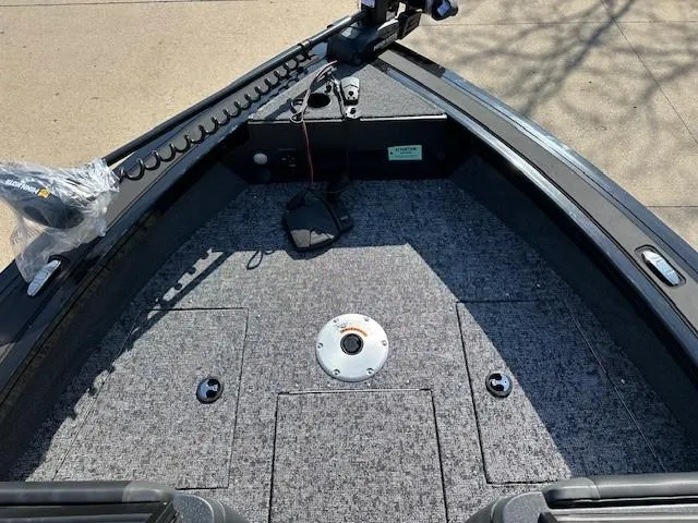 Slide: The Image of 2025 Tracker Targa V-18 WT boat deck with carpeted flooring and storage compartments. - 3