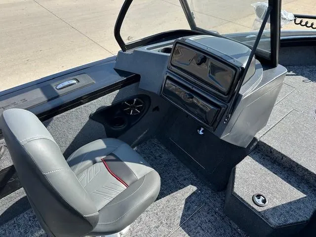 Slide: The Image of 2025 Tracker Targa V-18 WT boat interior with gray seating and dashboard. - 5