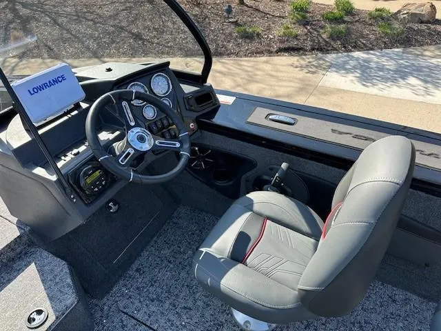Slide: The Image of 2025 Tracker Targa V-18 WT boat interior with steering wheel and navigation system. - 6