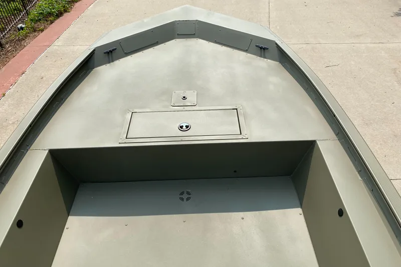 Slide: The Image of 2025 Tracker Grizzly 1754 Jon boat, spacious deck, olive green finish, outdoor setting. - 3