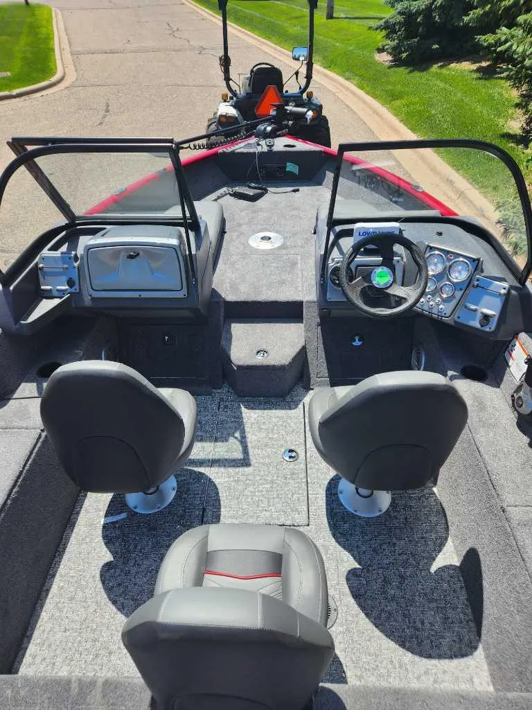 Slide: The Image of 2025 Tracker Pro Guide V-175 Combo boat interior with seating and control panel. - 5