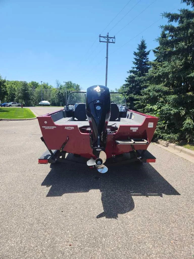Slide: The Image of 2025 Tracker Pro Guide V-175 Combo boat, rear view, parked on a sunny day. - 6