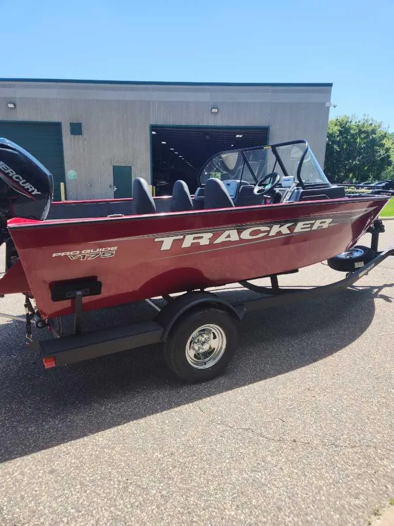 Slide: The Image of 2025 Tracker Pro Guide V-175 Combo boat on trailer, parked outdoors. - 7