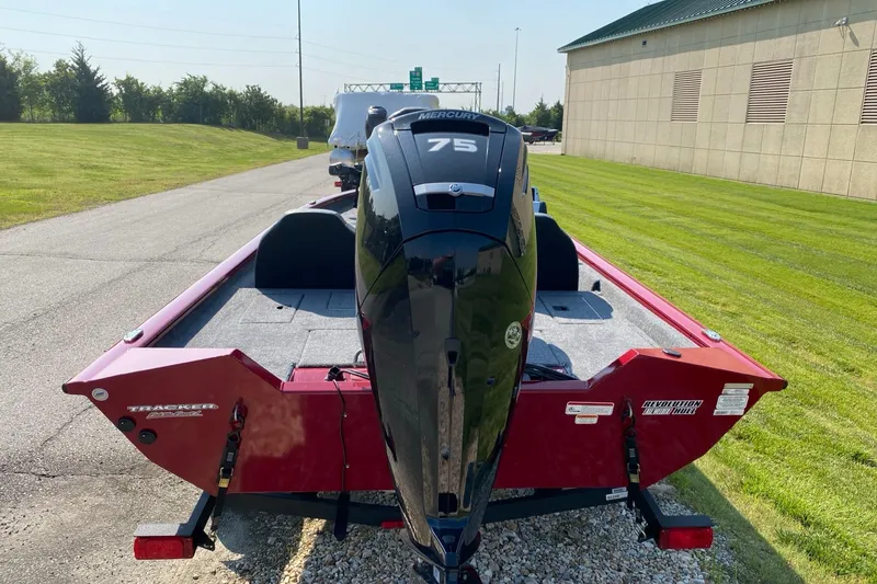 Slide: The Image of 2025 Tracker Pro Team 175 boat with 75 HP engine, parked on a sunny day. - 4