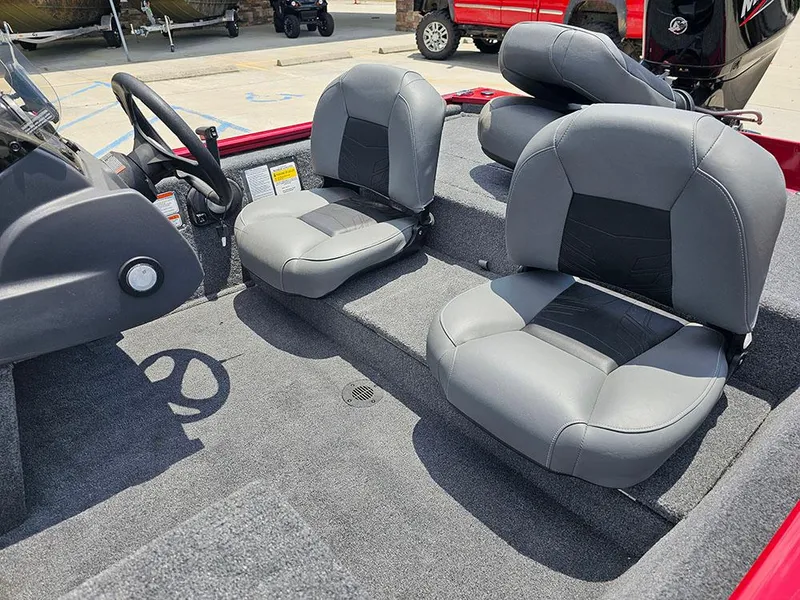 Slide: The Image of 2025 Tracker Pro 170 boat interior with gray seating and steering wheel. - 12