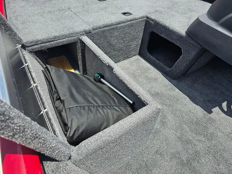 Slide: The Image of 2025 Tracker Pro 170 boat storage compartments with carpeted interior. - 15