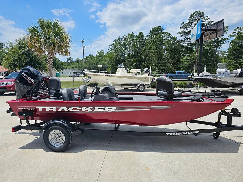 Slide: The Image of 2025 Tracker Pro 170 boat in red on trailer, parked outdoors. - 6