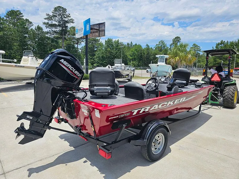Slide: The Image of 2025 Tracker Pro 170 boat with Mercury engine on trailer, parked outdoors. - 7