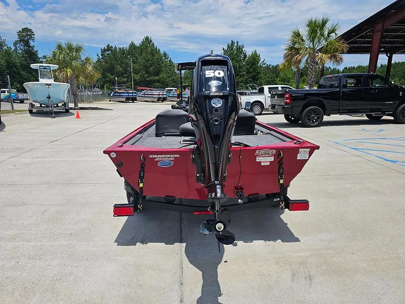 Slide: The Image of 2025 Tracker Pro 170 boat with outboard motor in a parking lot. - 8
