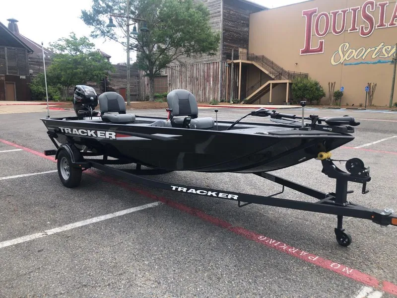 Slide: The Image of 2025 Tracker Panfish 17 boat on trailer in parking lot near Louisiana Sportsman store. - 6