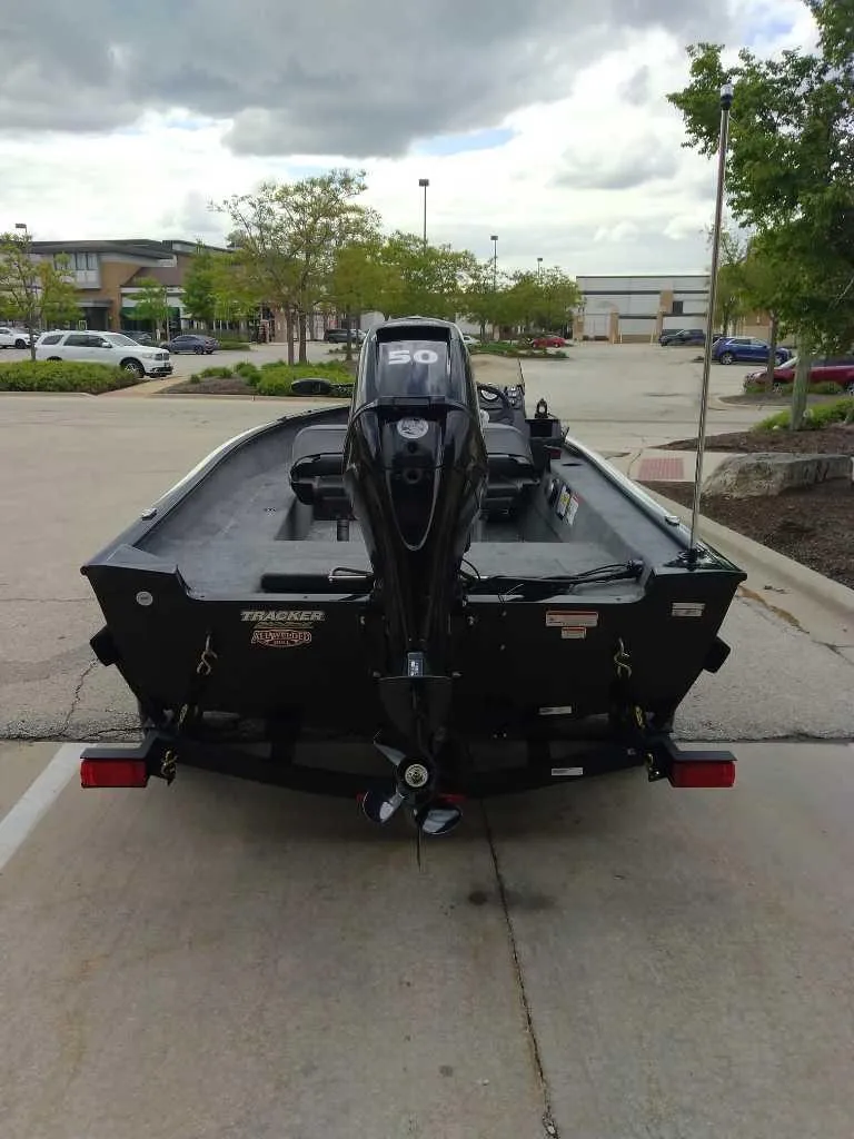 Slide: The Image of 2025 Tracker Super Guide V-16 SC boat in parking lot, rear view. - 4
