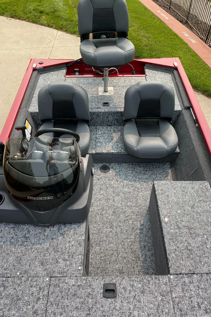 Slide: The Image of 2025 Tracker Pro 170 boat interior with three gray seats and carpeted flooring. - 4