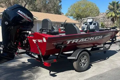 Slide: The Image of 2025 Tracker Pro Team 175 boat with Mercury engine, parked on trailer, outdoors. - 3