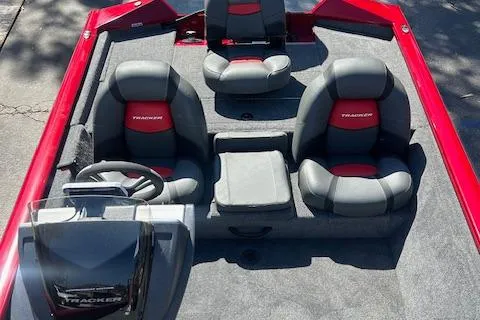 Slide: The Image of 2025 Tracker Pro Team 175 boat interior with gray and red seating, steering console, and storage. - 6