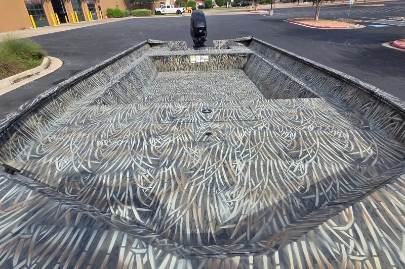 Slide: The Image of 2025 Tracker Grizzly 2072 Utility boat with camouflage pattern in a parking lot. - 15