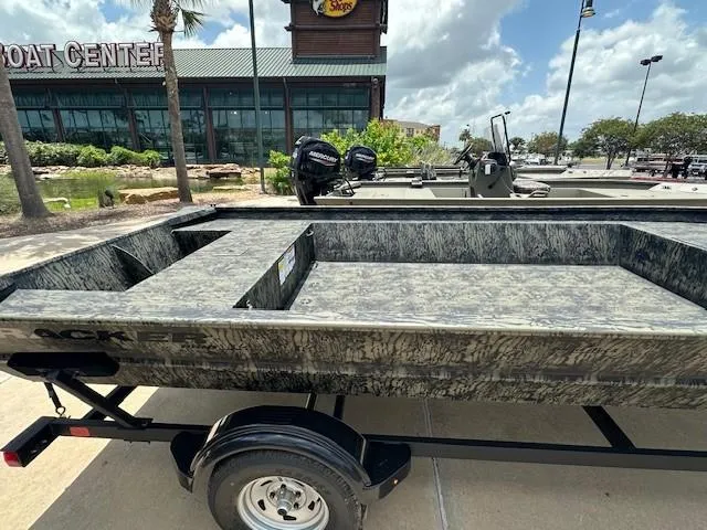 Slide: The Image of 2025 Tracker GRIZZLY 2072 Utility boat on trailer outside a boat center. - 2