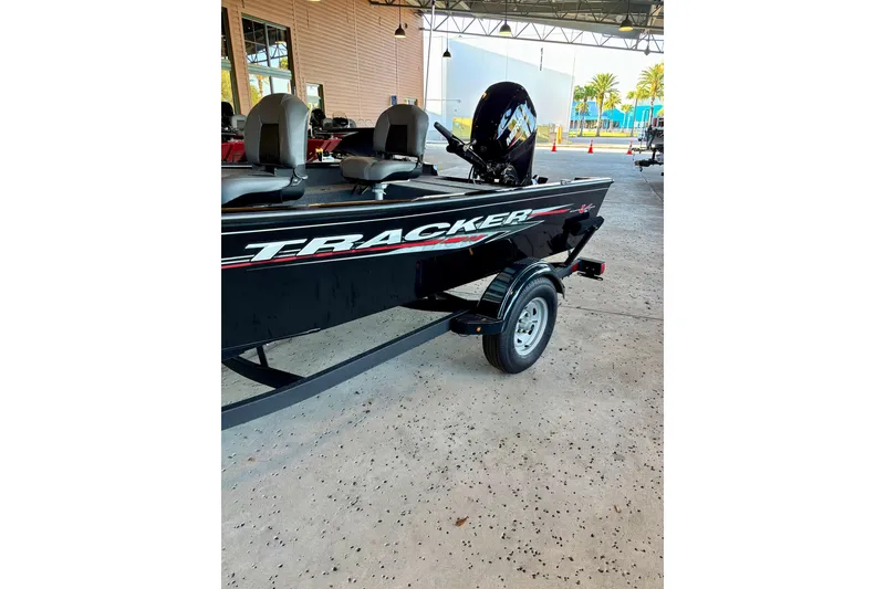The Image of 2025 Tracker Super Guide V-16 T boat on trailer, parked indoors. - 0