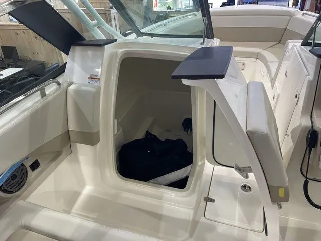 Slide: The Image of 2025 Boston Whaler 240 Vantage boat interior with open storage compartment. - 10