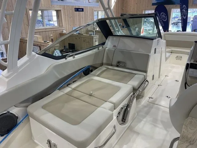 Slide: The Image of 2025 Boston Whaler 240 Vantage interior with beige seating and modern design. - 11