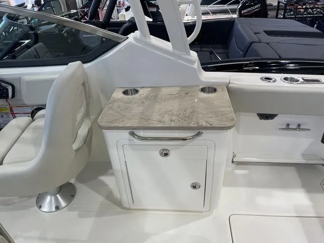 Slide: The Image of 2025 Boston Whaler 240 Vantage interior with seating and storage area. - 13
