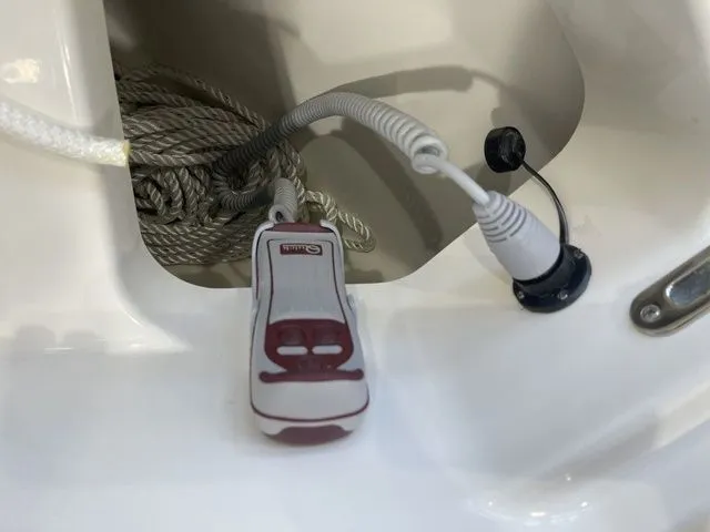 Slide: The Image of Boston Whaler 240 Vantage 2025 boat detail with coiled rope and electronic device. - 15