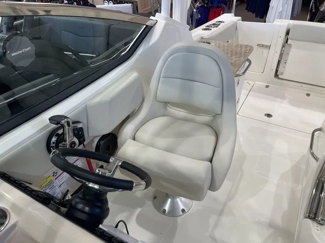 Slide: The Image of 2025 Boston Whaler 240 Vantage boat interior with steering wheel and seating. - 18