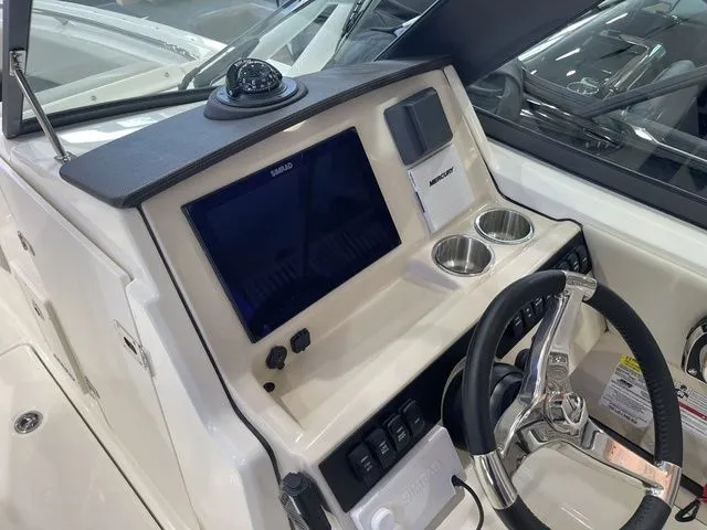 Slide: The Image of 2025 Boston Whaler 240 Vantage dashboard with modern controls and navigation system. - 20