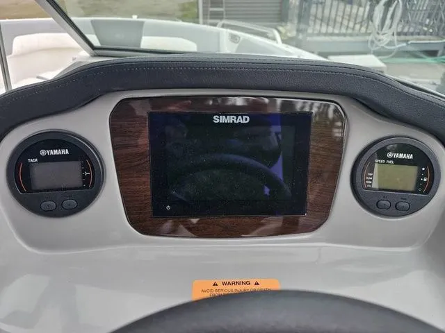 Slide: The Image of Dashboard of 2023 Chaparral 23 SSi OB boat with Simrad display and Yamaha gauges. - 10