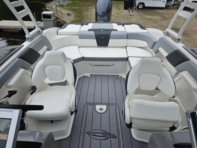 Slide: The Image of 2023 Chaparral 23 SSi OB boat interior with white seating and gray flooring. - 5