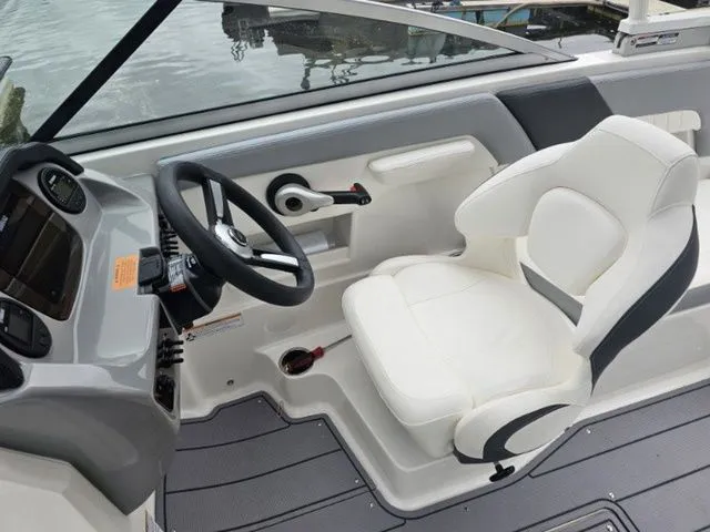 Slide: The Image of 2023 Chaparral 23 SSi OB boat cockpit with white captain's seat and steering wheel. - 6