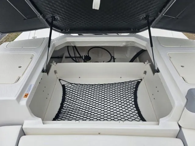 Slide: The Image of Open storage compartment of 2023 Chaparral 23 SSi OB boat with netting. - 7
