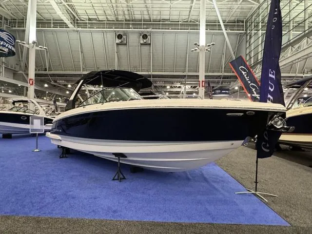 Slide: The Image of 2024 Chaparral 307 SSX boat displayed indoors on blue carpet. - 1