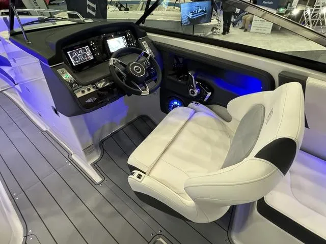 Slide: The Image of 2024 Chaparral 307 SSX boat cockpit with modern controls and luxurious seating. - 11