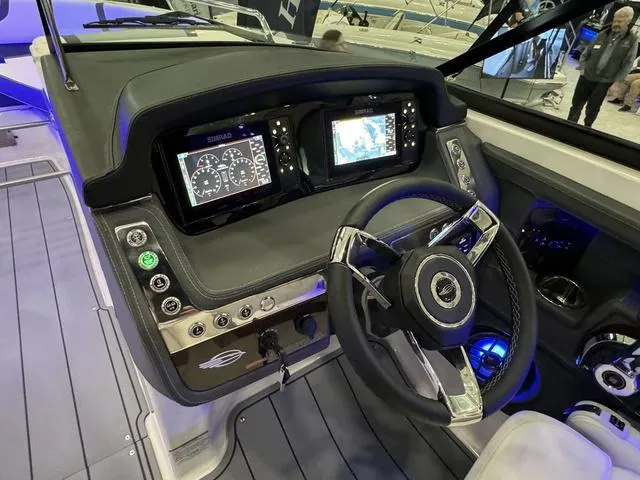 Slide: The Image of 2024 Chaparral 307 SSX boat dashboard with modern controls and dual display screens. - 12