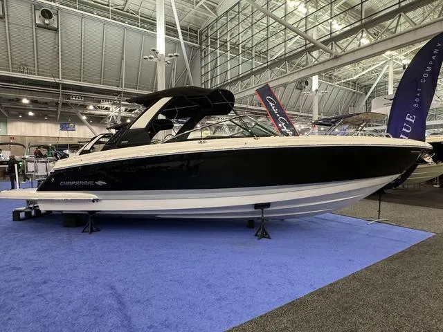 Slide: The Image of 2024 Chaparral 307 SSX boat displayed indoors on blue carpet. - 2