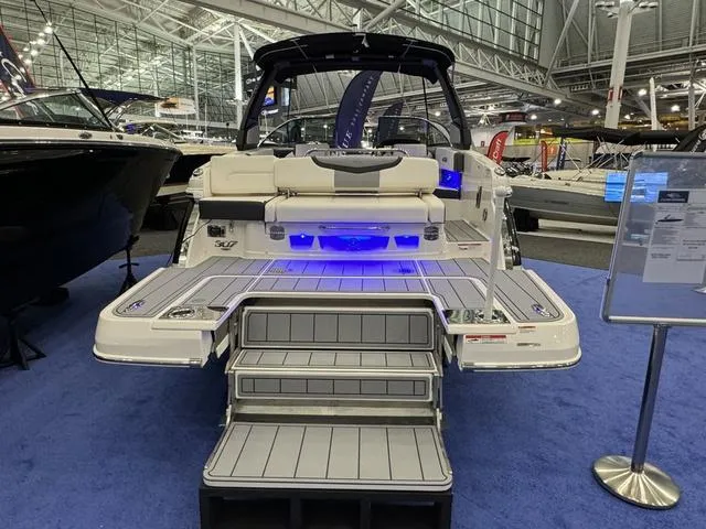 Slide: The Image of 2024 Chaparral 307 SSX boat with illuminated deck at an indoor exhibition. - 4